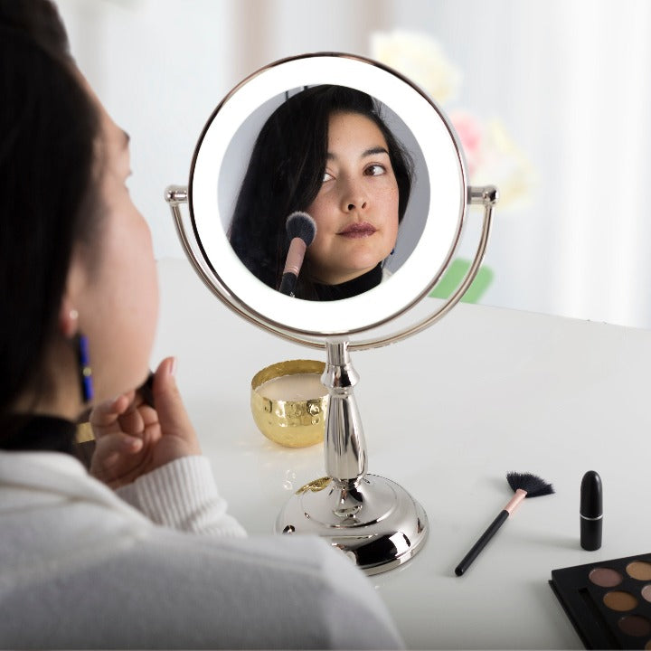 Zadro LEDVPRT410 705004420921 in-use photo front view user applying makeup, lighted makeup mirror with magnification & touch base in a real life setting