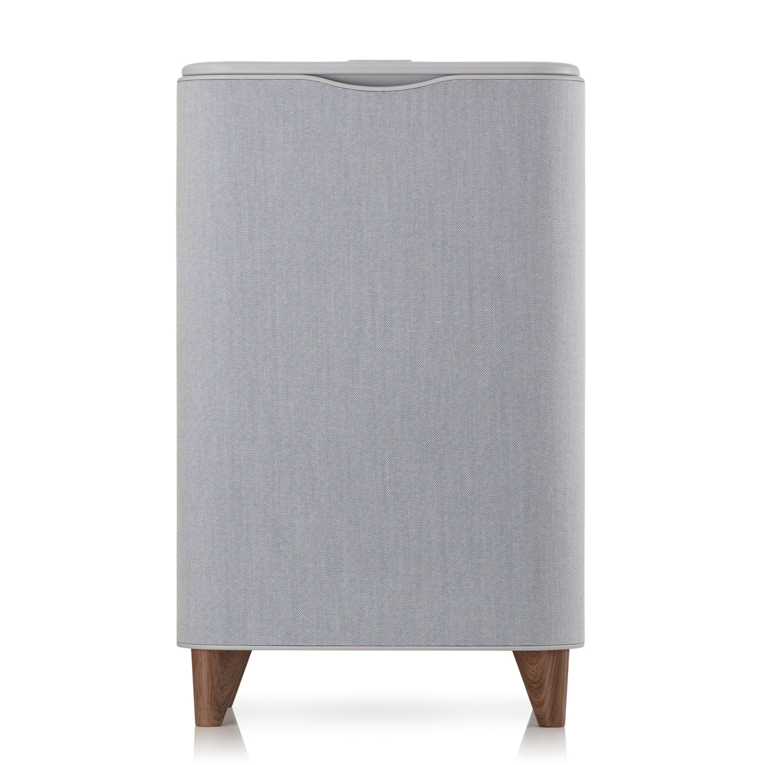 Gray upholstered towel warmer with wooden legs on a white background