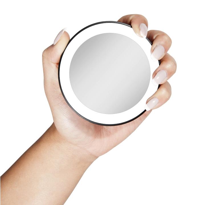 Zadro MLED15X 705004421423 product photo user holding mirror, lighted compact mirror with magnification & suction cup in front of a white background