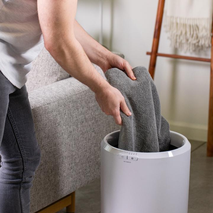 Zadro TWB01 705004422918 environment photo user removing towels, large towel warmer bucket in front of a real life setting