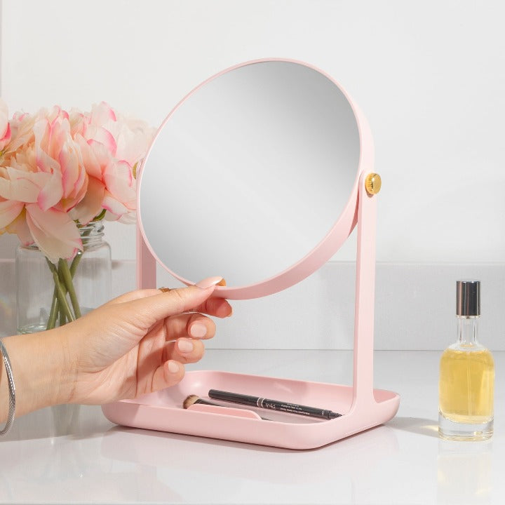 Zadro ZBVT2002 705004423434 environment photo in use hand adjusting mirror, back-to-school makeup mirror with accessory tray & phone holder in front of a real life setting